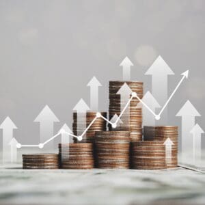 Coin stacks with upward trending graph.
